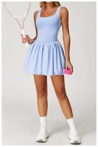 Detail of light blue tennis dress featuring a stylish square neck and pleated bubble skirt
