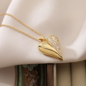 18K gold plated heart necklace with zircon inlay on cream satin background