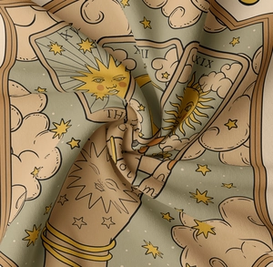 Macro shot of tarot tapestry fabric showing detailed Sun pattern and vintage textures