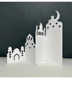 Detail of 3D laser-cut white card with Islamic mosque silhouette and star moon pattern