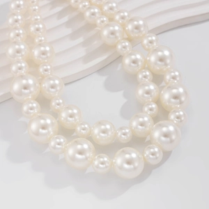 Detailed view of elegant double-layer white pearl necklace with gradient bead sizes