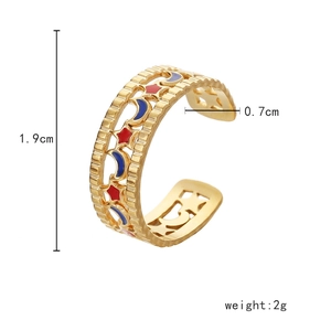 Macro detail of gold adjustable ring with hollow stars and moon enamel patterns