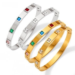 Macro detail of hinged stainless steel bracelets with colorful square cut zircons