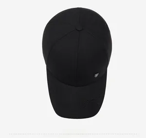 Vue de dessus d'une casquette noire avec broderie de montagne et logo métallique argent