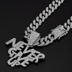 Close-up of hip hop silver Cuban chain with diamond-encrusted NEVER GIVE UP letter pendant