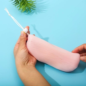 Detailed macro view of 6-layer thickened pink foaming net bag with white drawstring