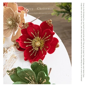 Close-up of velvet Christmas flowers with gold glitter accents and Merry Christmas text