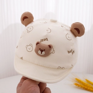 Close-up of baby sun hat featuring plush bear ears and soft cotton texture