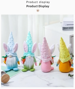 Set of four pastel Easter gnomes with bunny ears and carrots on a marble tabletop