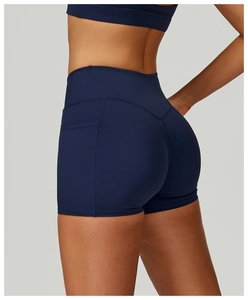 Detail of high-waisted navy blue yoga shorts featuring practical side pockets and stitching