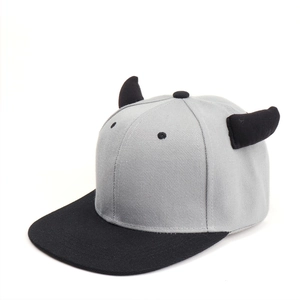 Detail view of the black devil horns stitched on a grey and black snapback baseball cap