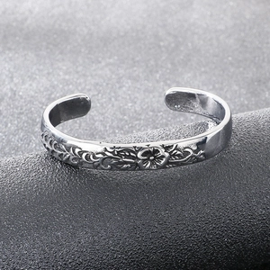 Close-up of vintage floral engraved silver cuff bracelet with intricate ethnic patterns