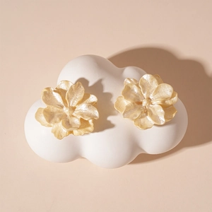 Vue détaillée de boucles d'oreilles fleurs en acrylique nacré sur plateau nuage