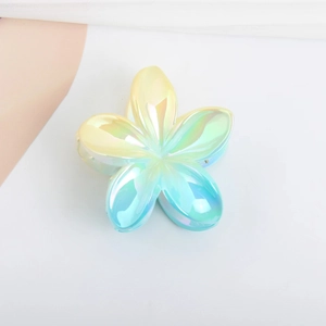 Macro view of gradient laser-effect frangipani hair claw with high-gloss finish