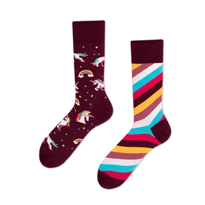 Detail view of cotton socks featuring cartoon unicorn patterns and multi-color stripes