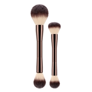 Detail view of dual-ended makeup brushes with brown gradient bristles and metallic handle