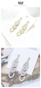 Macro detail of luxury layered teardrop bridal earrings in gold and silver finish