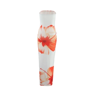 Close-up of red and orange floral patterns on a white strapless slim-fit maxi dress