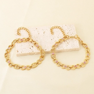 Elegant gold-tone link bracelet featuring 8mm pink zircon accents and adjustable lobster clasp