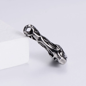 Detail of vintage stainless steel Viking pendant with Thor's hammer and skull motif
