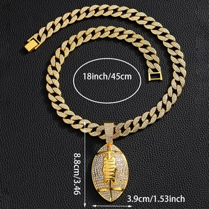 Macro detail of iced-out football pendant on gold cuban chain with size measurements