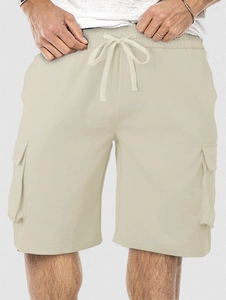 Detail view of men's beige cargo shorts featuring elastic drawstring waist and side pockets
