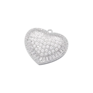 Detailed view of silver heart pendant with white pearls and sparkling zirconia stones