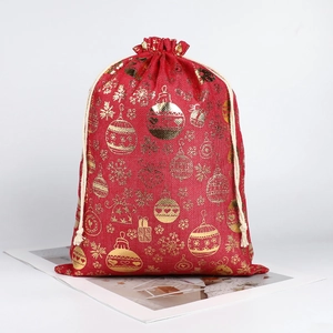 Large red Christmas drawstring gift bag with gold foil snowflake and ornament prints