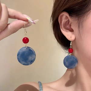 Minimalist geometric acrylic earrings in red and blue marble pattern with gold hooks