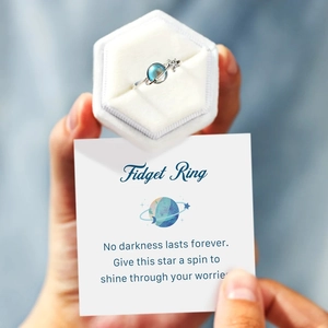 Close-up of rotatable S925 sterling silver fidget ring with stars and blue planet design