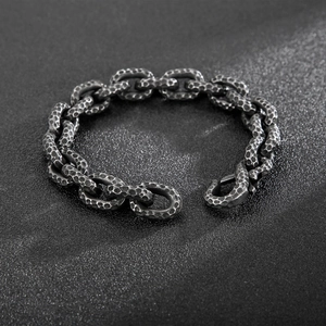 Macro shot of industrial hammered texture and sturdy links on vintage steel bracelet