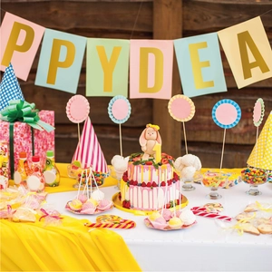 Detail of colorful macaron party decor set including paper bunting and striped hats