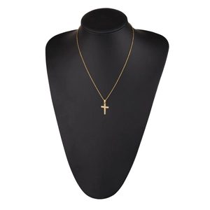 Polished gold cross pendant necklace displayed on a black neck mannequin stand