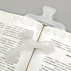 Set of two large translucent white plastic book clips with a sleek bow-shaped design