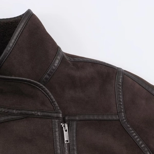 Close-up of brown faux suede jacket with leather piping, metal zipper and warm fleece lining