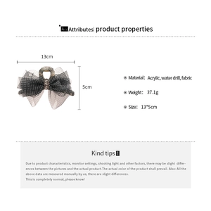 Detailed specs of acrylic hair claw with polka dot mesh bow and rhinestone accents