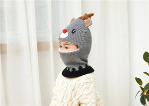 Detailed side view of child reindeer knitted hat with warm ear flaps and neck cover