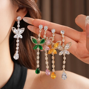 Detail view of butterfly drop earrings with cubic zirconia tassels in multiple colors