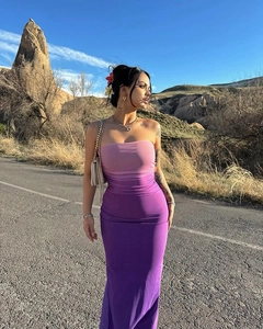 Detailed view of pink and purple gradient strapless bodycon dress on a model outdoors