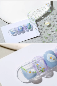 Detailed view of daisy nail art stickers featuring floral patterns and KX25 decals