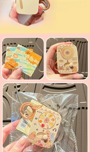 Detail of Capybara rotating toy keychain with light feature and original retail packaging