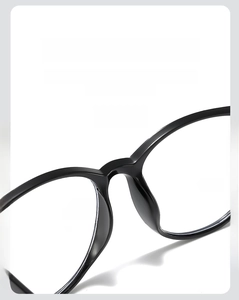 Detail of ergonomic one-piece nasal tray on black full-rim glasses for pressure relief