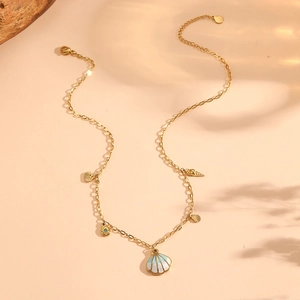 Gold stainless steel ocean necklace featuring shell and conch pendants in blue enamel