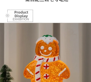 Close-up of glowing gingerbread man music box requiring three AAA batteries