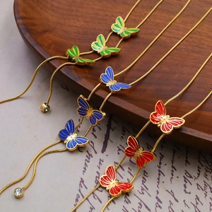 Elegant butterfly enamel pendant necklace set in blue, red, and green with gold snake chain