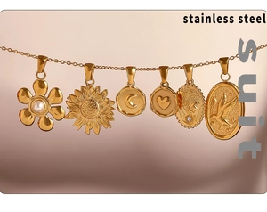 Detail view of 18K gold plated stainless steel pendants set with flower and sun motifs