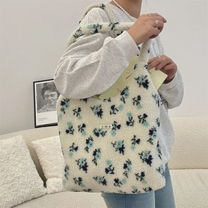 Detail of plush floral tote bag showing soft sherpa texture and brand label