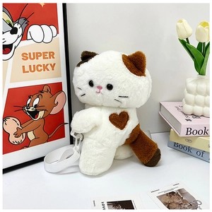 Detail of calico plush cat bag with heart embroidery and adjustable white strap