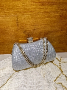 Sparkling silver sequin evening clutch bag with metal chain strap and diamond buckle
