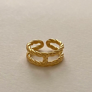Detail of gold twisted rope ring featuring a central H-shaped connector link